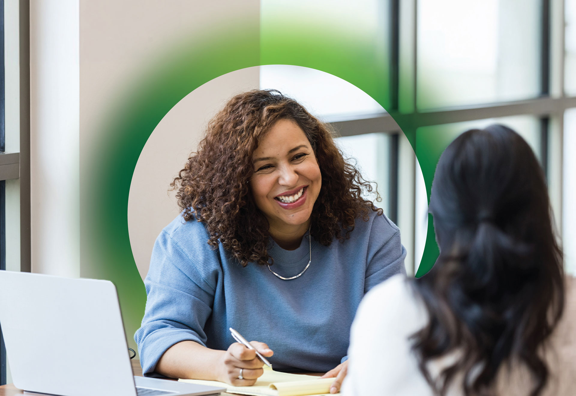 Securian Canada HR employee smiles while interviewing a candidate.