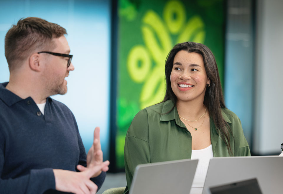 Two Securian Canada colleagues share a conversation in an office setting.