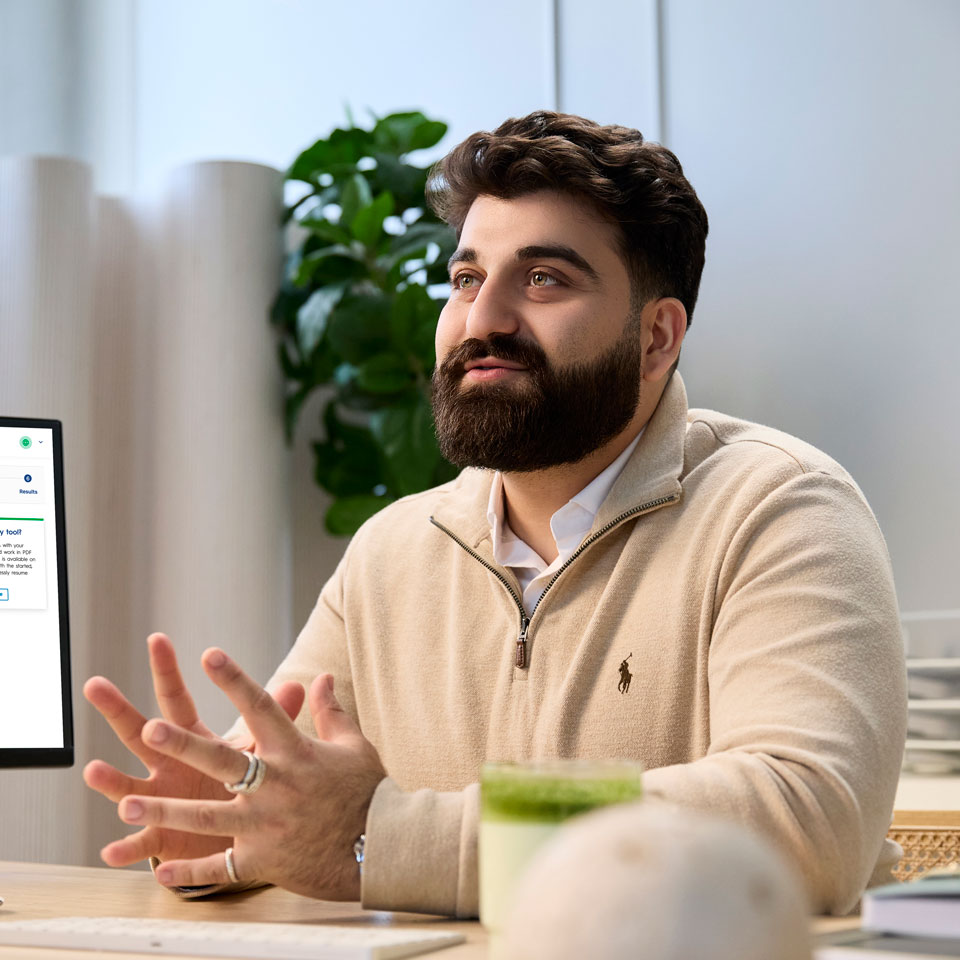Person with a beard gestures with his hands in an office.